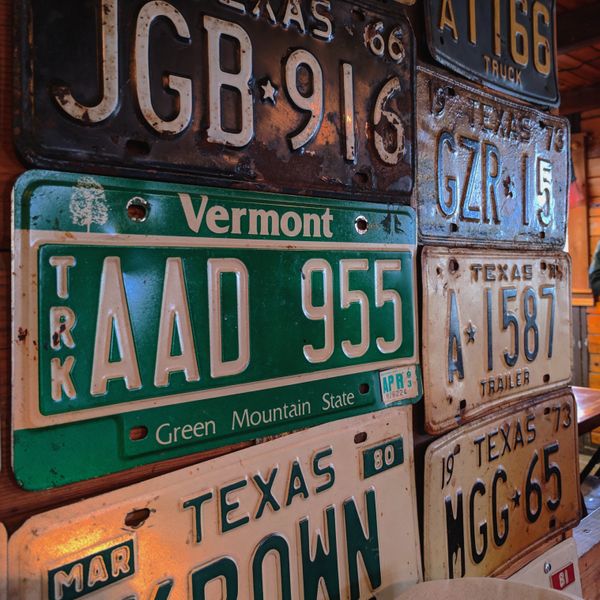 Vermont and Texas license plates on the wall of a BBQ joint in the Texas hill country.