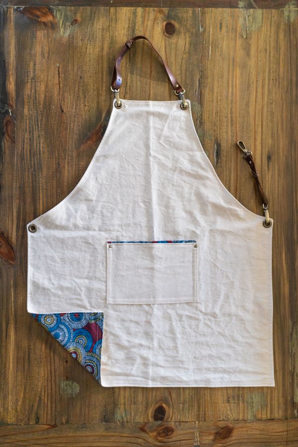 Front of the apron with a corner folded up showing the lining.